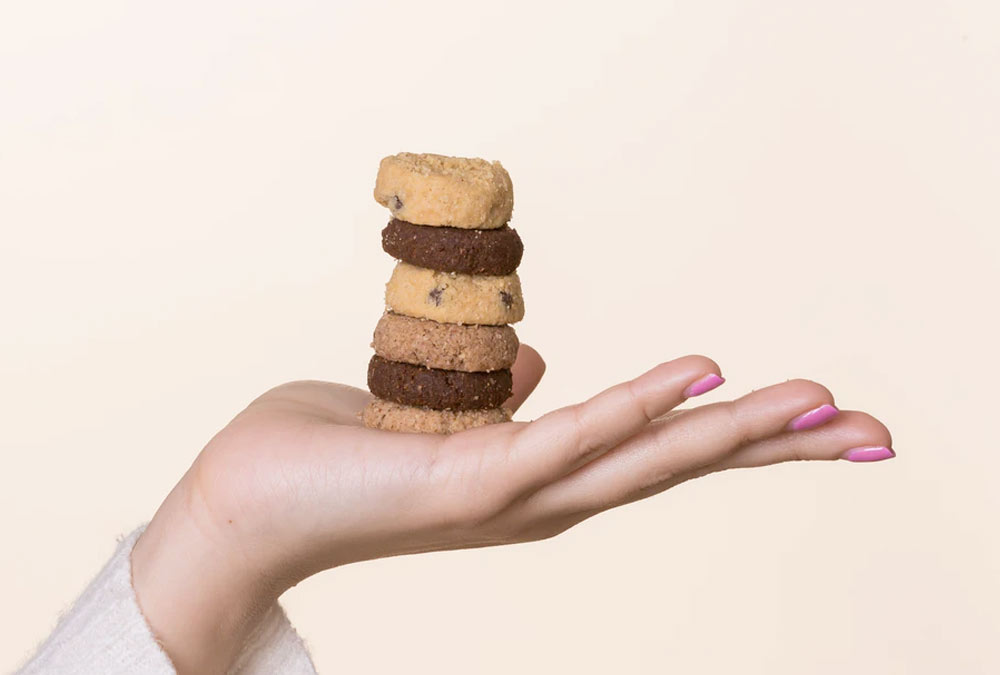 Female Hand Holds Cookies that Represent Third-Party Cookies